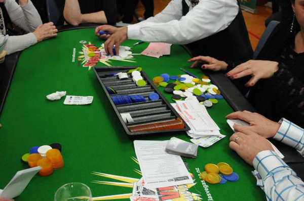 Cashing in chips at the Poker table at end of night for cheques